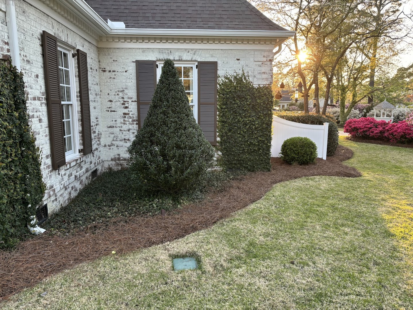 JB technician servicing an irrigation control box at a home, Wilmington NC